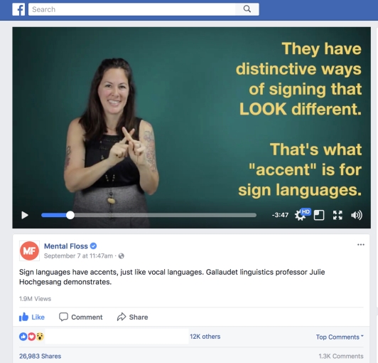 Screenshot of a Facebook post by Mental Floss showing a video with a woman in mid-sign